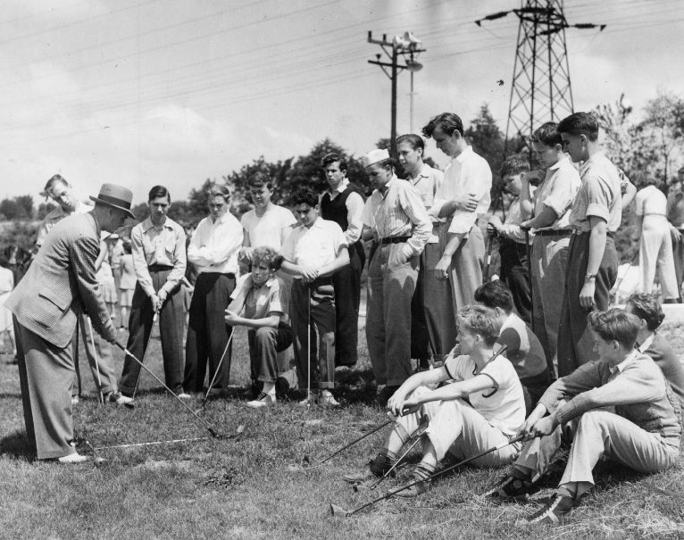 #100 Alex Ayton, St. Louis Country Club professional, instructs a class of boy beginners in the fundamentals of the swing, 1940