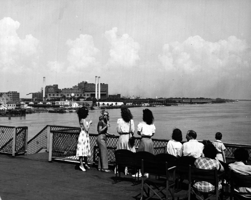 #53 Passengers overlook the Mississippi River as they visit the top deck of the President steamboat.