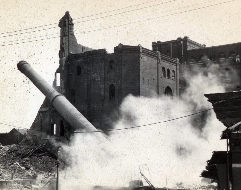 #75 Wainwright Brewery Razing, 1945. Demolition of the Wainwright Brewery building on 10th and Gratiot street. The amount of smoke increases as the majority of the side building and the pillar collapse.