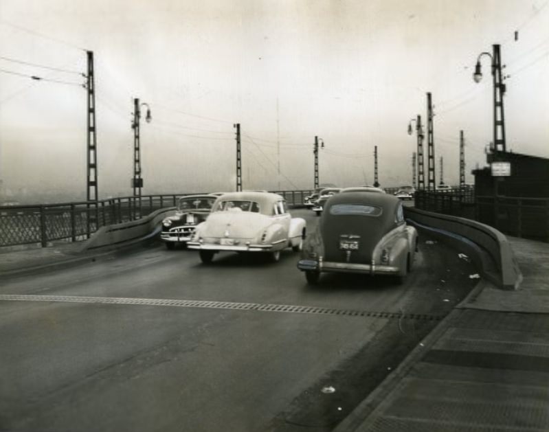 #109 Heavy steel guard rails at the curb line protect curves on the east approach to MacArthur Bridge, where three persons have been killed in less than eight days, 1950