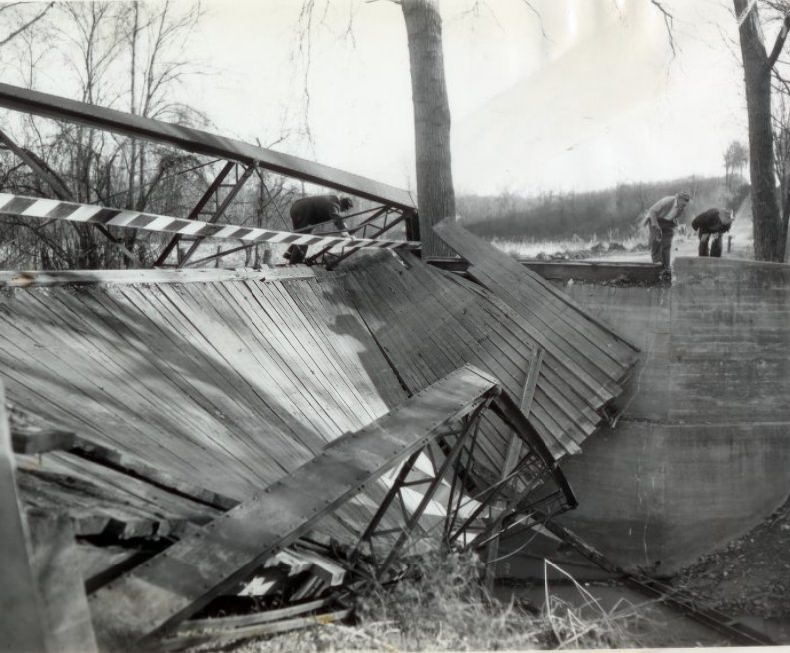 #93 Boards and girders hang crazily after this one-lane bridge on Old Baumgartner road over Mattese Creek in south St. Louis, 1955