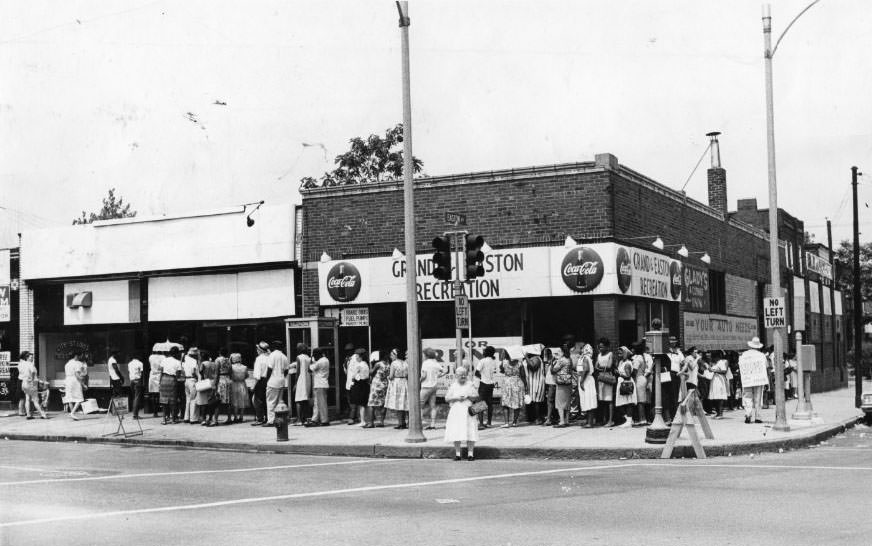 #10 People stand in line for food stamps at St. Louis Food Stamp Office, 1325 North Grand Avenue, 1960