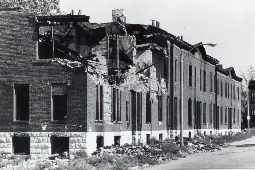 #143 A building deteriorates as the roof begins to fall apart and the inside of the building’s structure can be seen, 1974