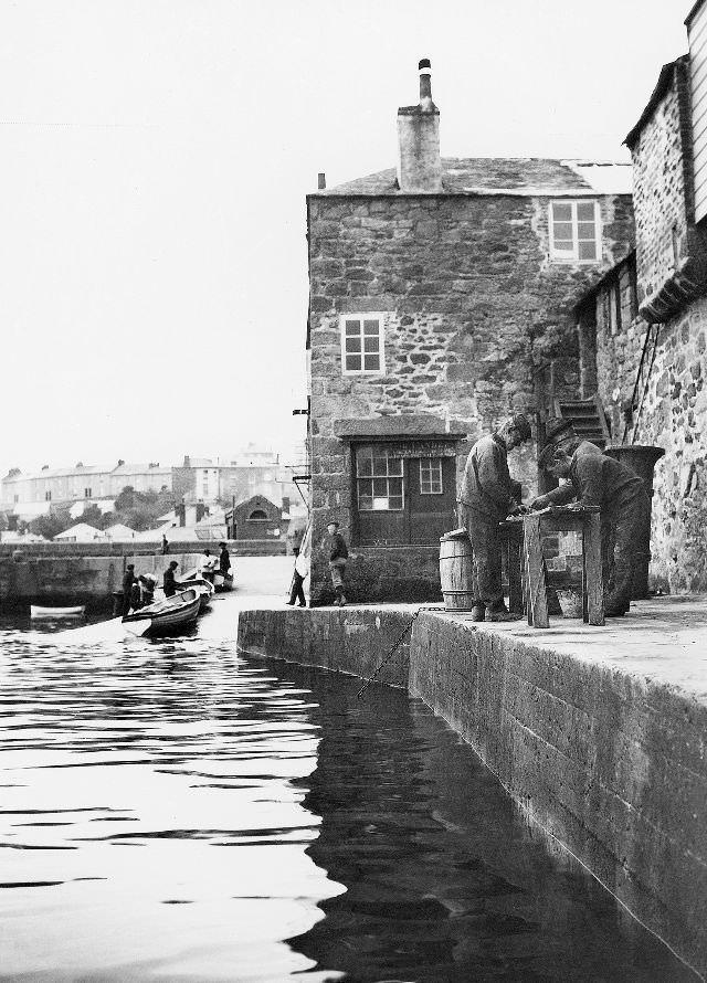 #29 A view of the wharf with some fisherman occupied with a task at a crude bench/table, St. Ives, Cornwall