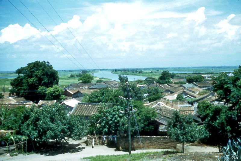 #36 A view from a monastery showing the rooftops of the clustered houses below and the bay beyond, Taiwan, Tainan, 1954