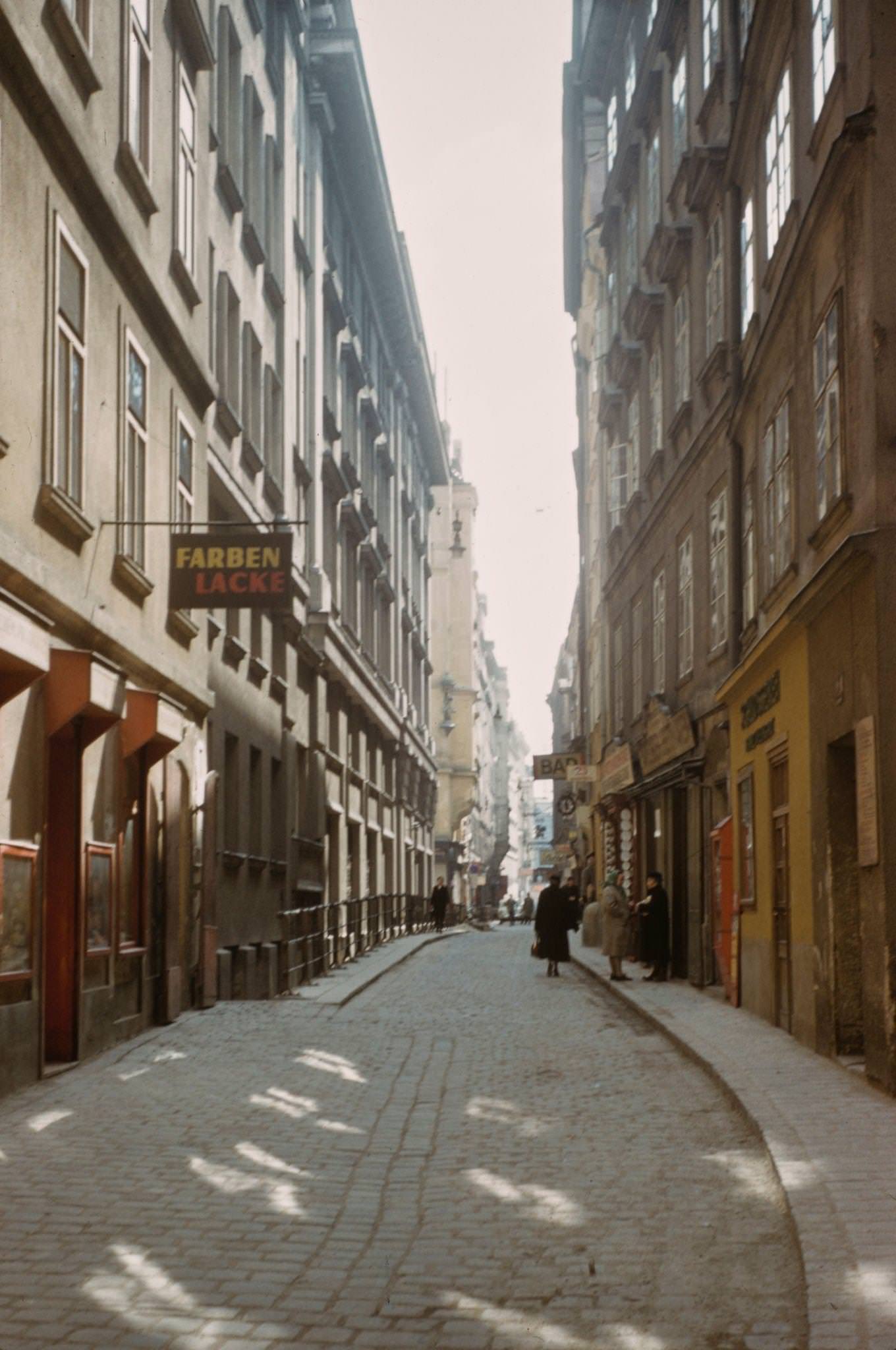 #27 Pedestrians walking down a narrow street in the centre of Vienna in 1950.