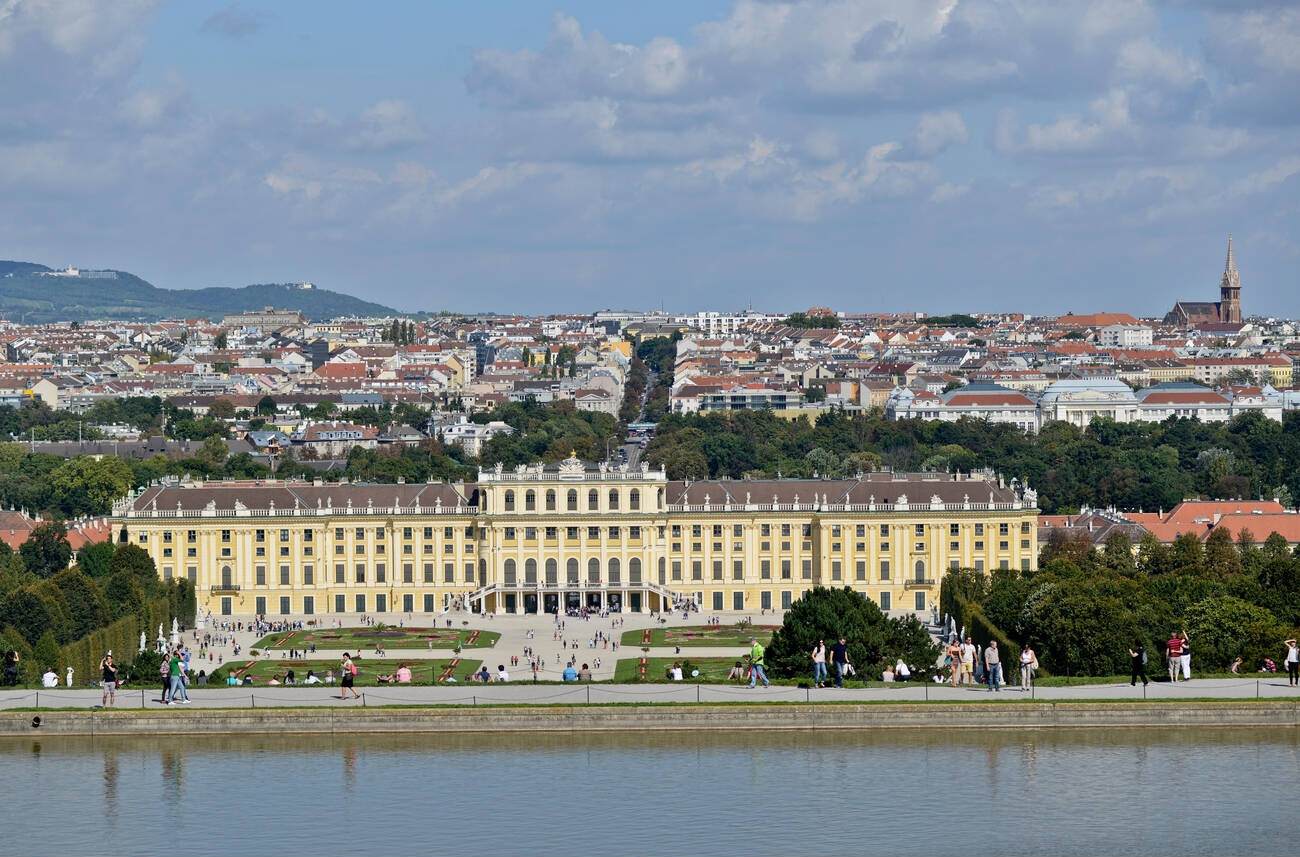 #99 Aerial view of Schönbrunn Palace in Vienna, Austria, with the garden in the front and the city in the background.