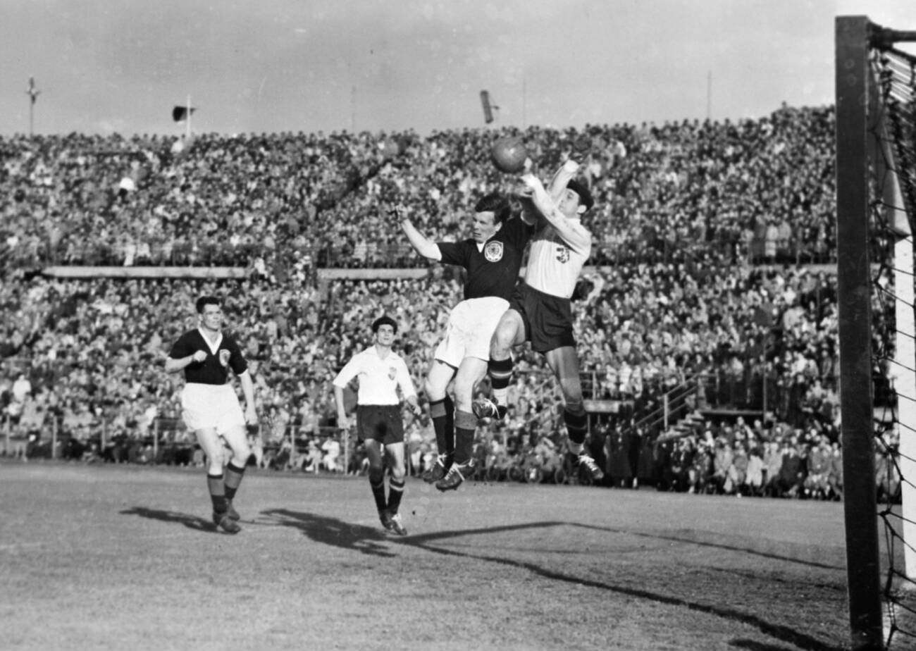 #37 A tussle for the ball in front of the football match between Austria and Scotland at Vienna Stadium, May 1955.