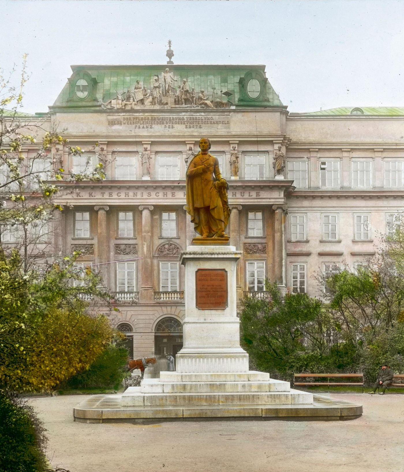 #28 Monument of Josef Ressel in Ressel Park at Karlsplatz, with the technical college of Vienna in the background. Vienna, 4th district, 1900.