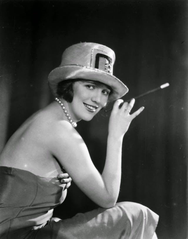 #18 British character actress Enid Stamp-Taylor (1904–1946) smoking with a long cigarette holder, 1926.