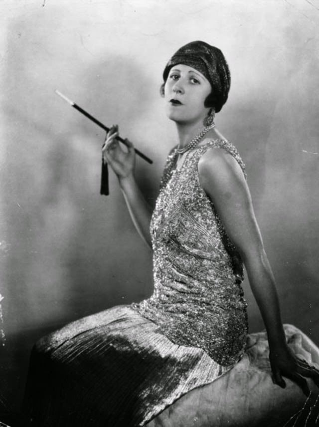 #20 Actress Betty Langford smoking with a cigarette holder, 1927.