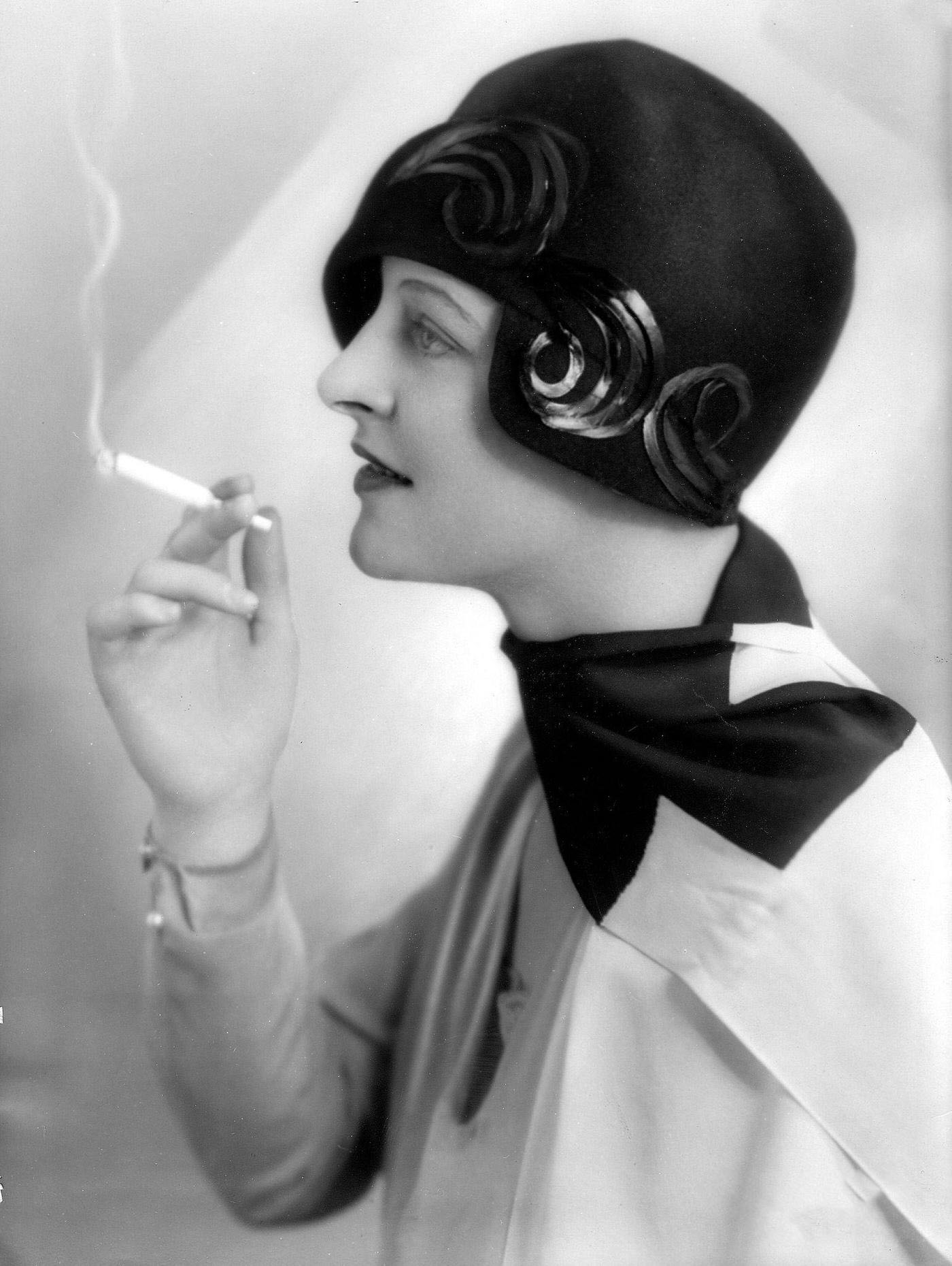 #45 Fashion Pictures: Miss d’Orloff Wearing Applique Hat, 1928: A Stylish Statement with a Cigarette