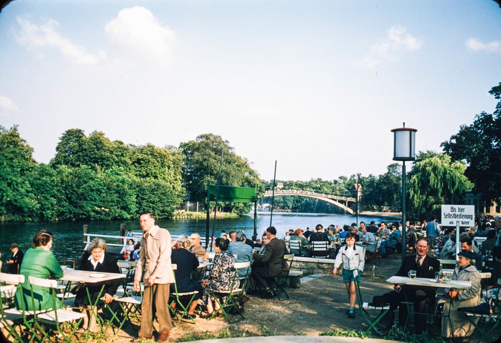 #136 This shot shows the same bridge from farther away, with Berliners enjoying a drink in the foreground.