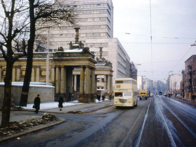 #35 Line 48 bus passing entrance to Kleist Park and the Allied Control Authority Building. New BVG headquarters are in the high-rise office building in rear, Berlin, 1954