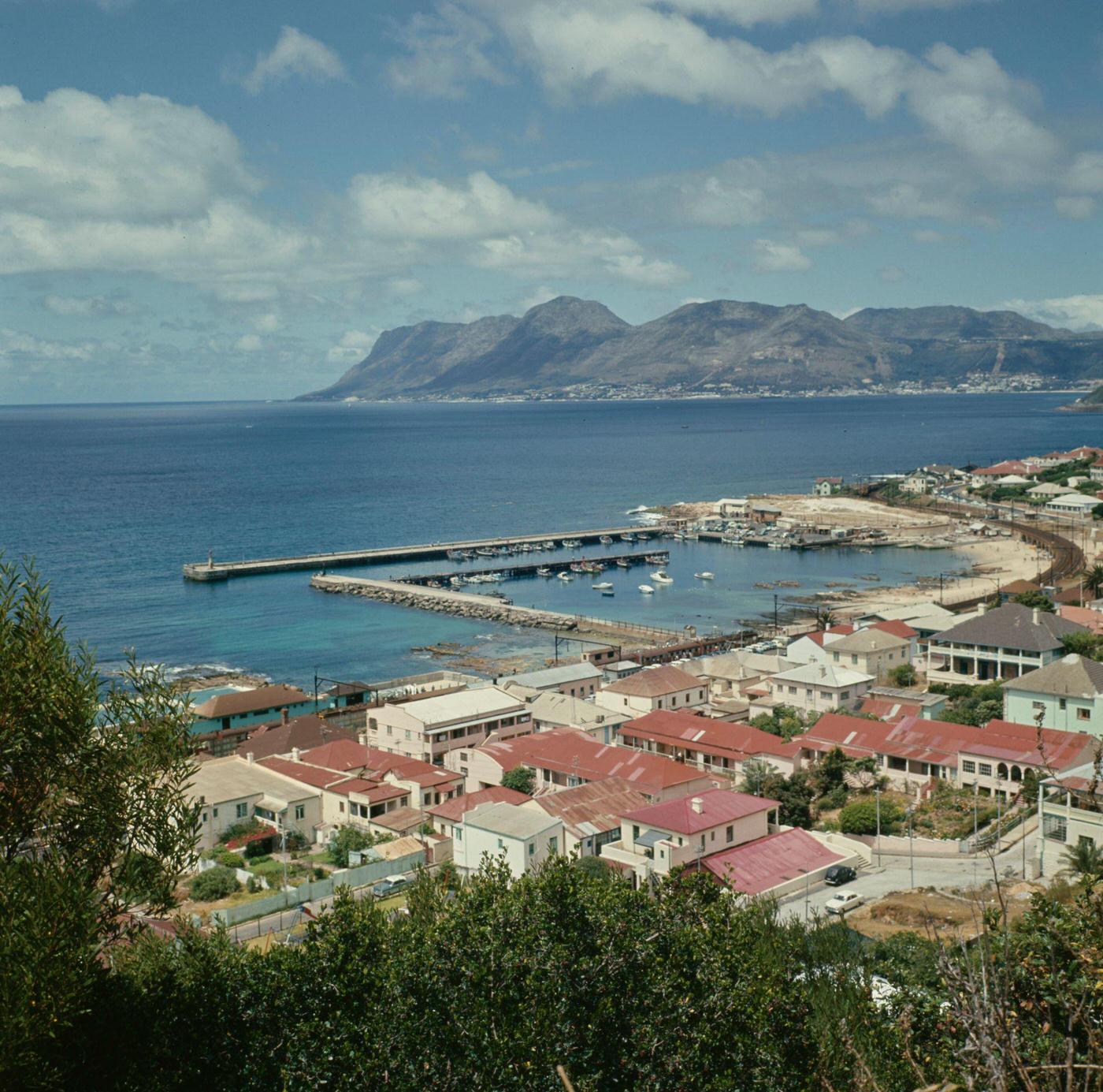 #91 Boats moored in the harbor of the fishing village of Kalk Bay on the coast of False Bay near Cape Town, 1966