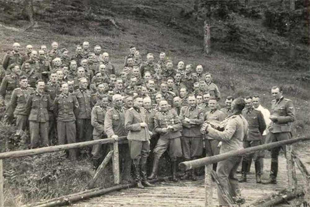 #11 Singing to release the stress: an accordianist leads a sing-along for SS officers.