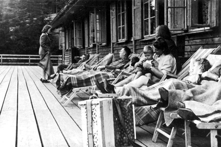 #8 SS officers relax together with women and a baby on a deck at Solahütte.