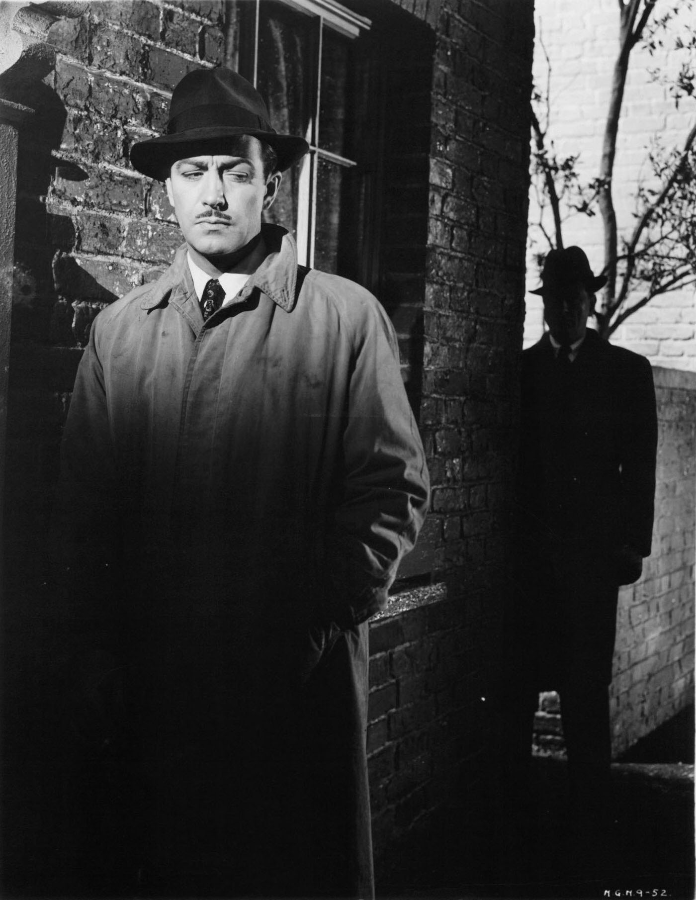 Robert Taylor being followed by a shadowy figure in a scene from the film ‘Conspirator’, 1949.