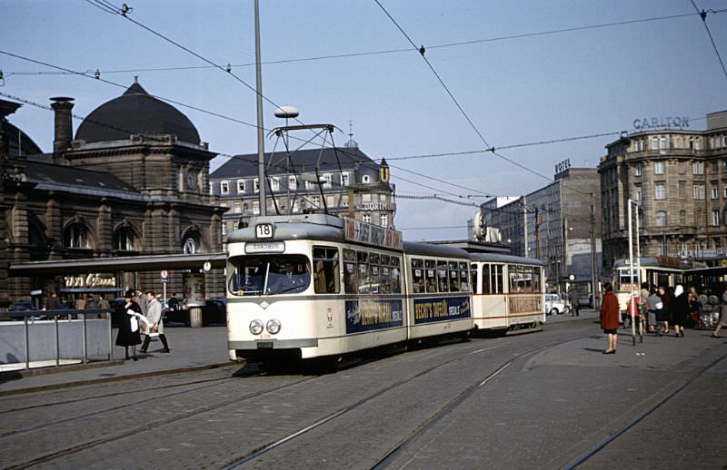 #1 Frankfurt M series articulated tram 608 (Düwag/1959) with what appears to be a K series trailer (Uerdingen/1945-47) on Route 18 outside Frankfurt Hauptbahnhof, March 30, 1967
