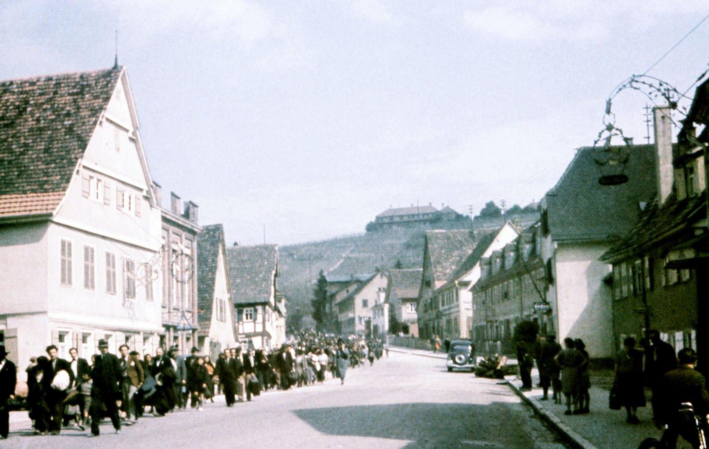 #9 Sinti under police surveillance marching in Asperg before being locked up at Hohenasperg prison prior to deportation to camps in Poland, May 22, 1940.