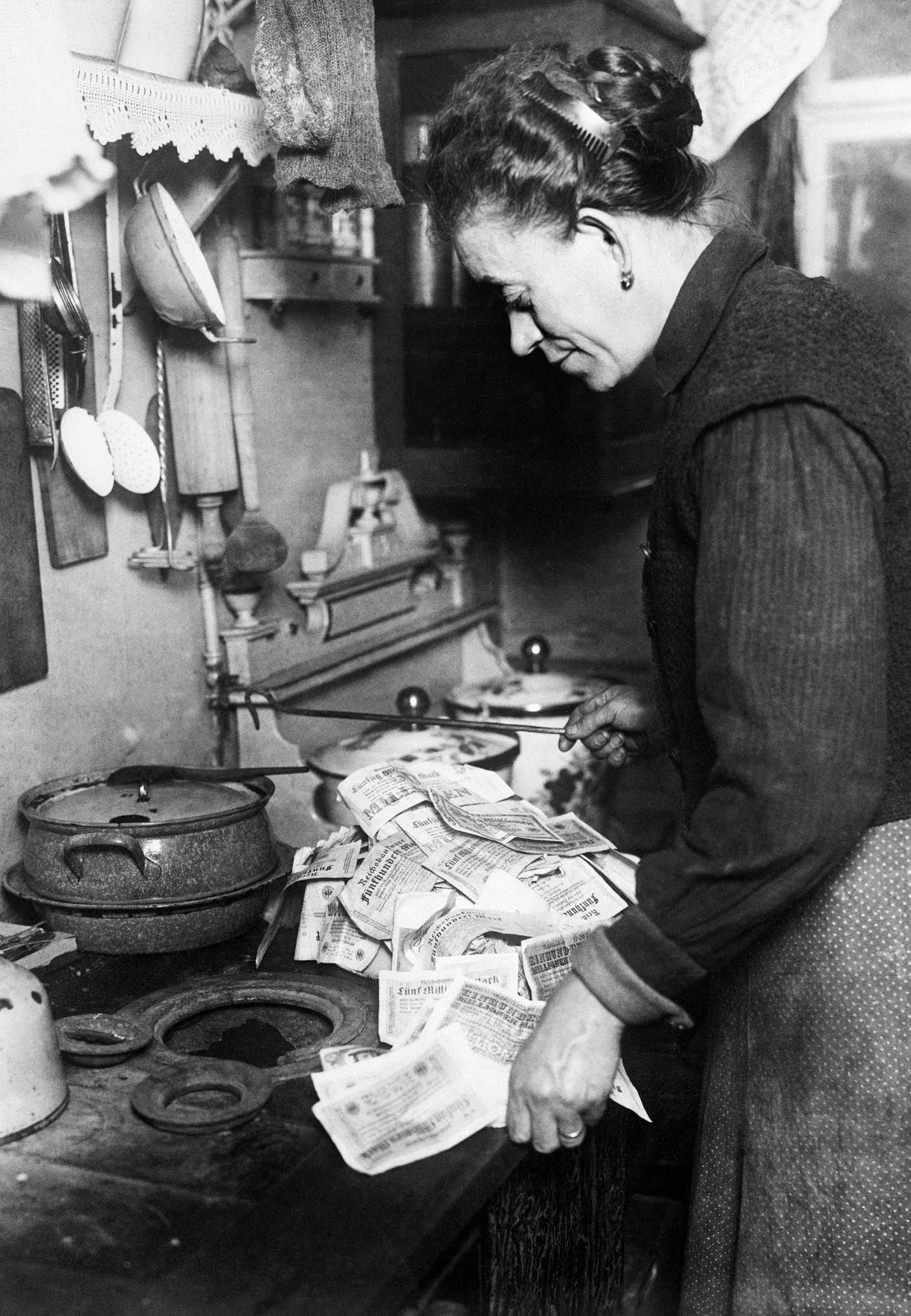 #1 Woman uses money to light stove, Germany’s hyperinflation.