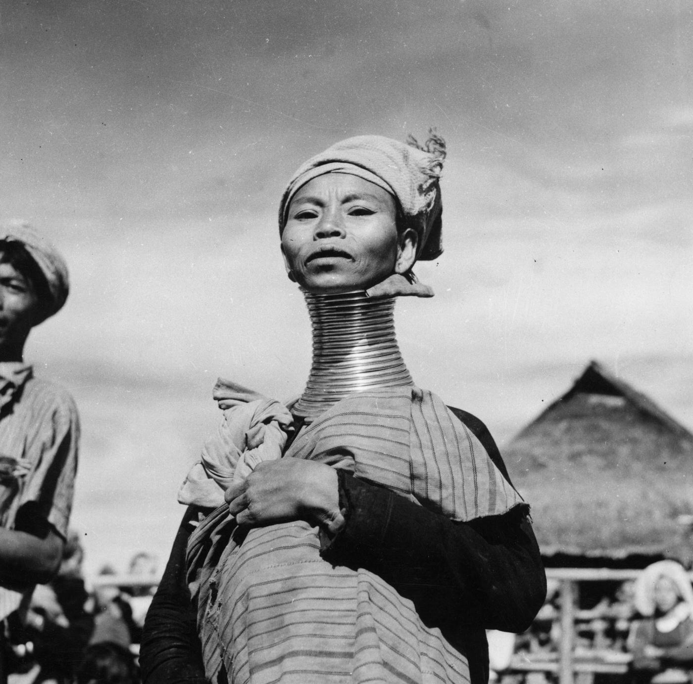 #14 A Padaung, or Kayan woman, known for the brass rings fitted to their necks and limbs, Burma, 1950.
