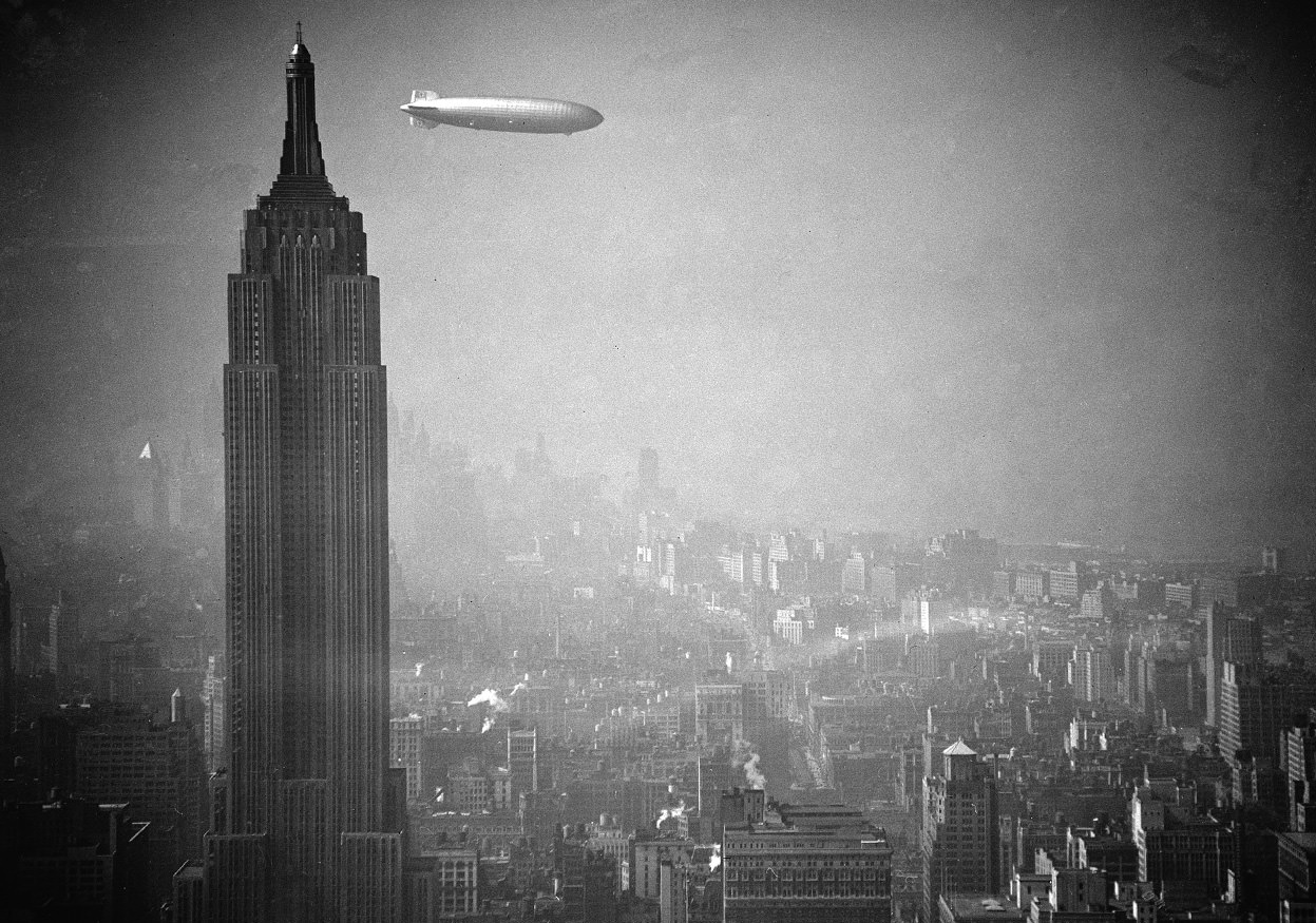 #11 The Zeppelin Hindenburg floats past the Empire State Building over Manhattan, Aug. 8, 1936