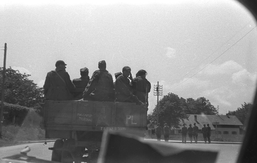 #22 Soldiers sit on a truck with the inscription “PW Camp Murnau.” It was this photo that gave Olivier Rempfer and his father, Aliain, the first clue as to where the photos where taken.