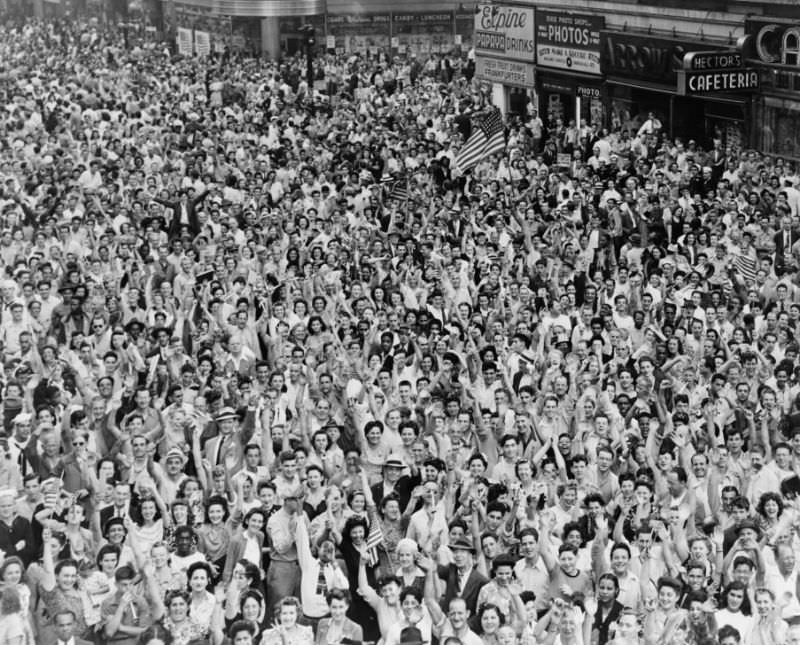 #17 Crowd of people, many waving, in Times Square on V-J Day at time of announcement of the Japanese surrender in 1945.