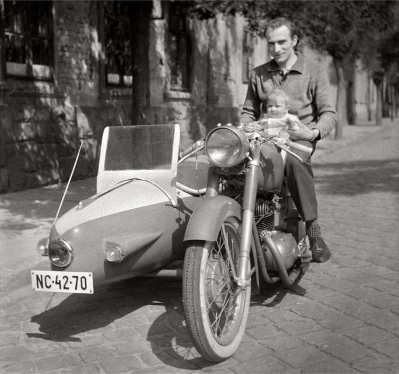 #37 Father holding his child on a Pannonia motorcycle and sidecar, somewhere in Hungary, 1950s