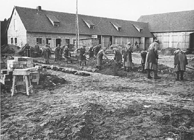 #16 Female prisoners at forced labor digging trenches at the Ravensbrück concentration camp. This photograph is from the SS-Propaganda-Album des Frauen-KZ-Ravensbrueck 1940-1941.