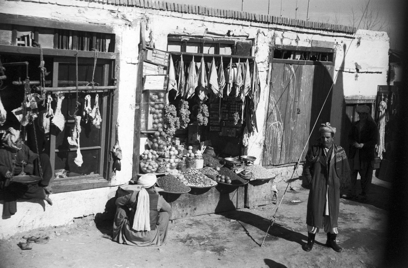 #44 People walking past stalls on the road to Kabul, 1950s