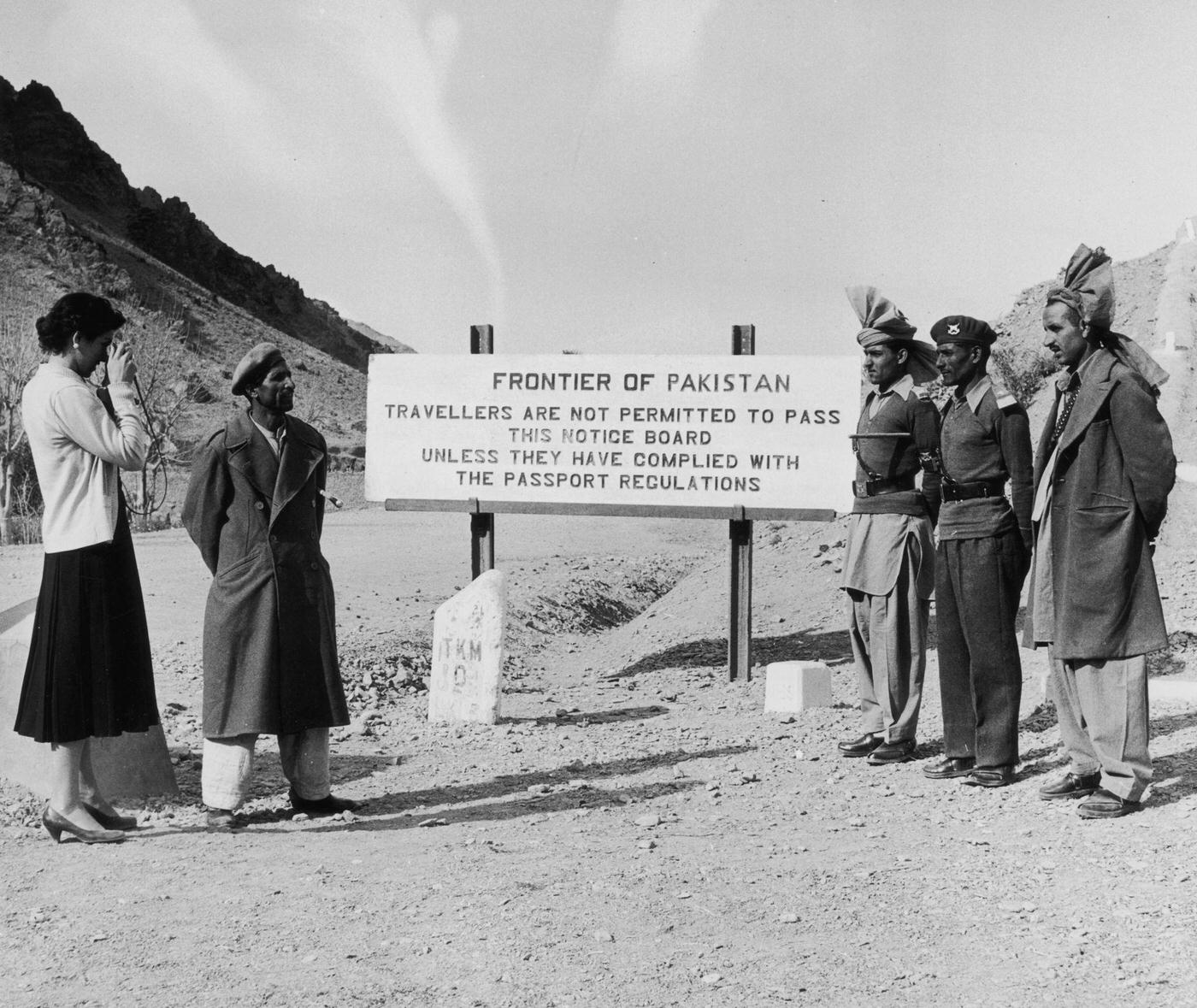 #56 Woman taking a photograph at the Pakistan-Afghanistan border, 1955.