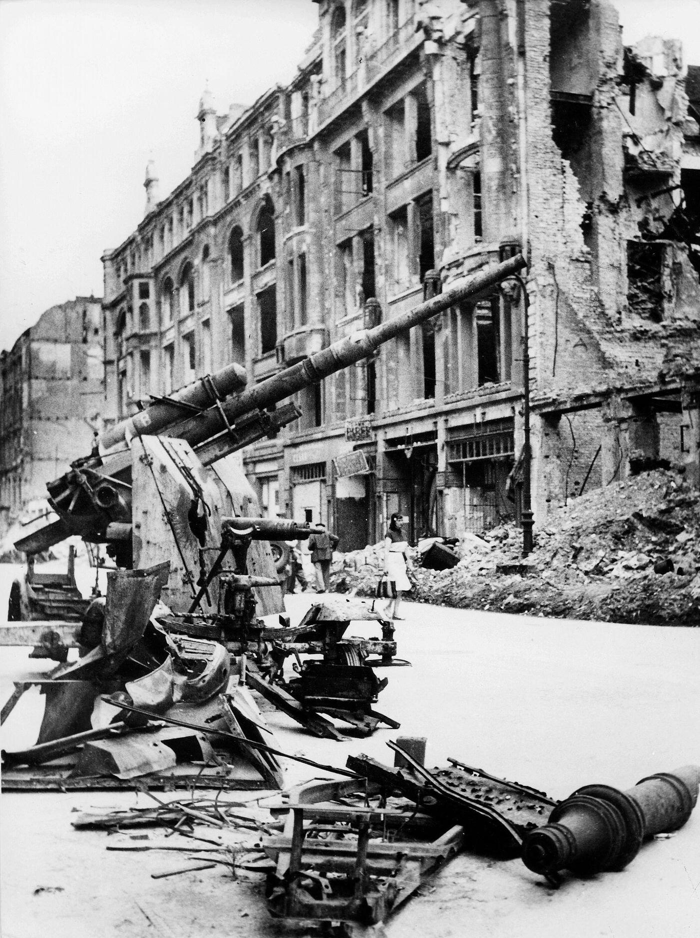 #14 Destroyed street in Berlin with a wrecked anti-aircraft gun, 1945.