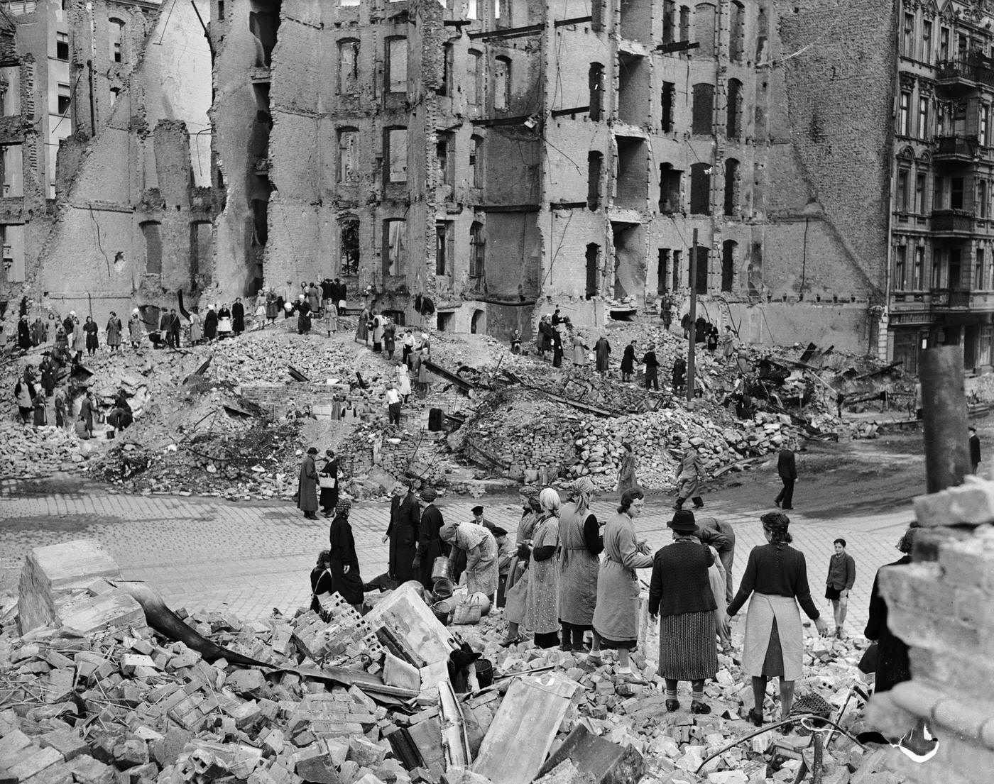 #29 Berlin women work in a ‘chain gang’ to clear rubble in the war-torn city.