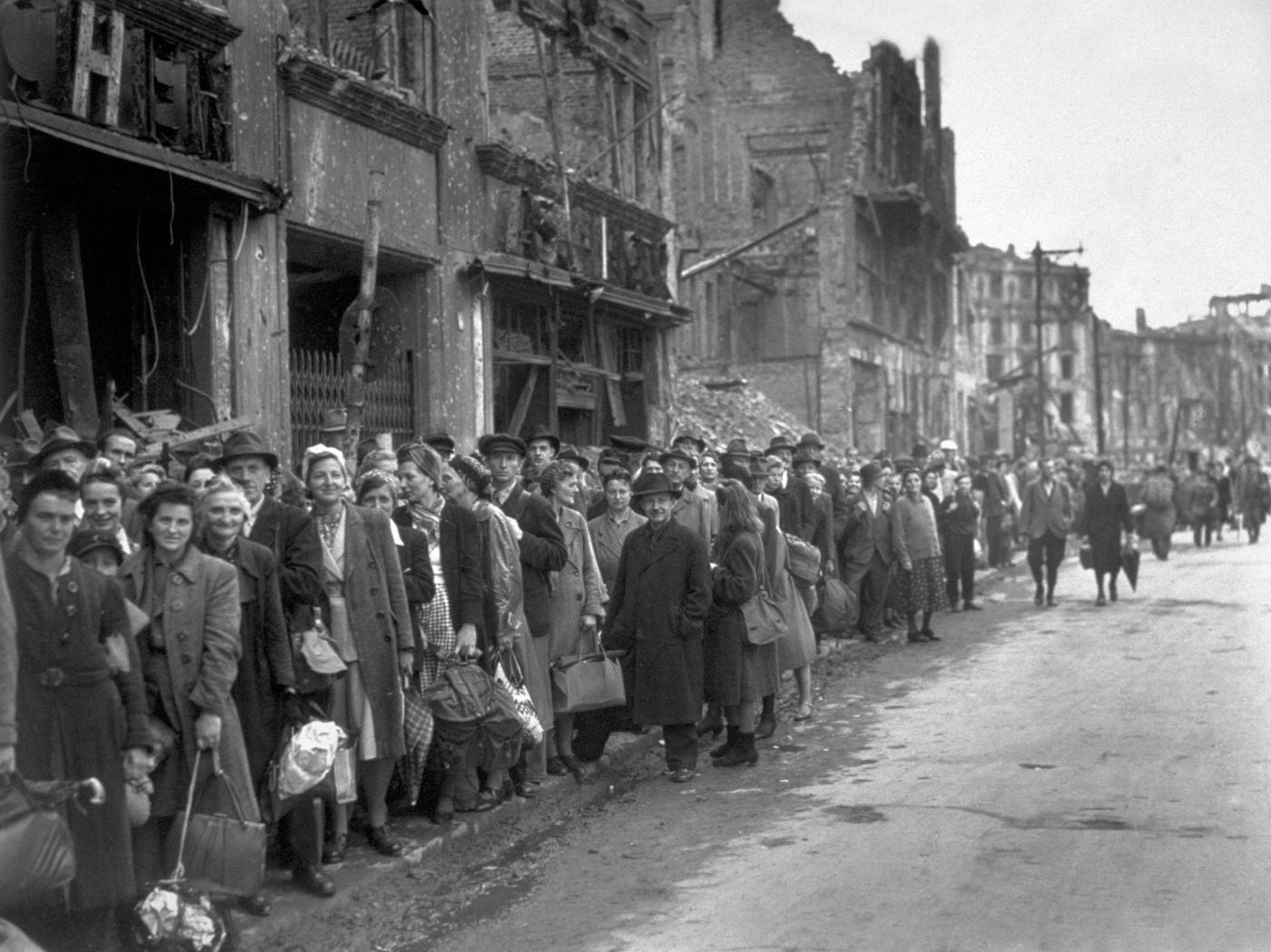 #55 Bus queue in a bomb-damaged street in Berlin, circa 1945.