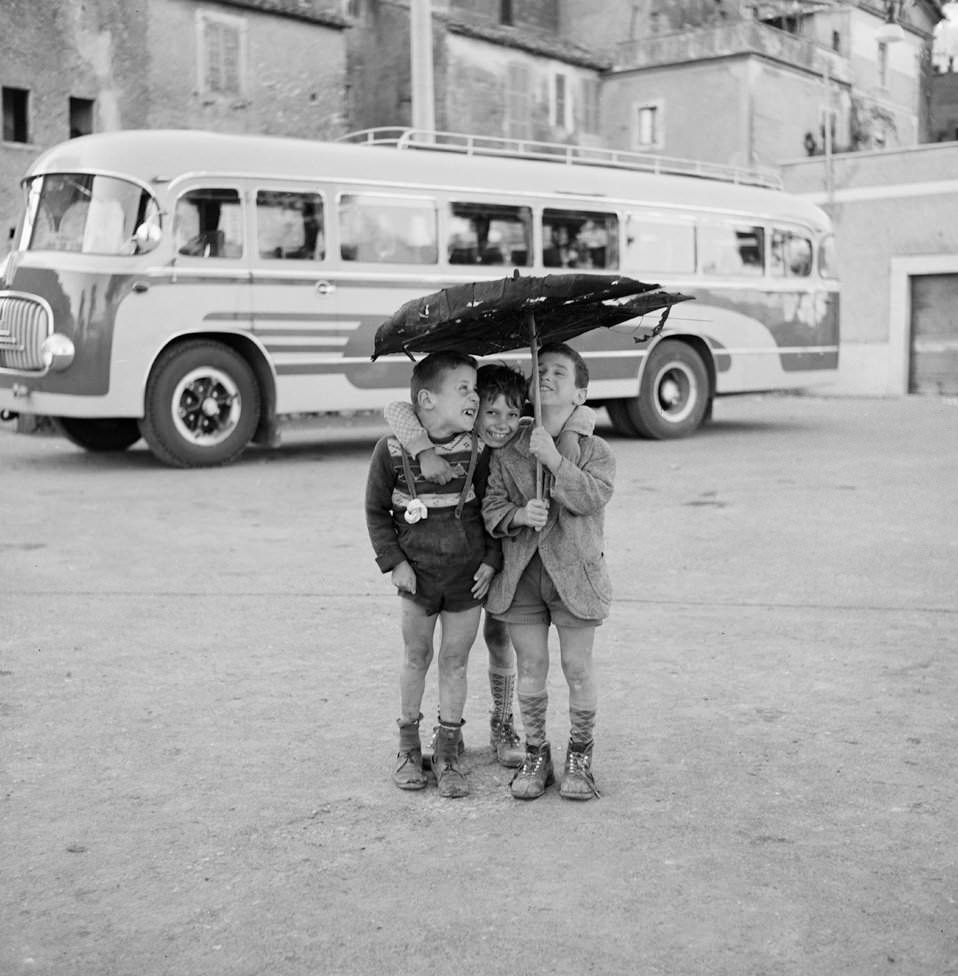#20 Three Boys Under an Umbrella, Rome, 1956