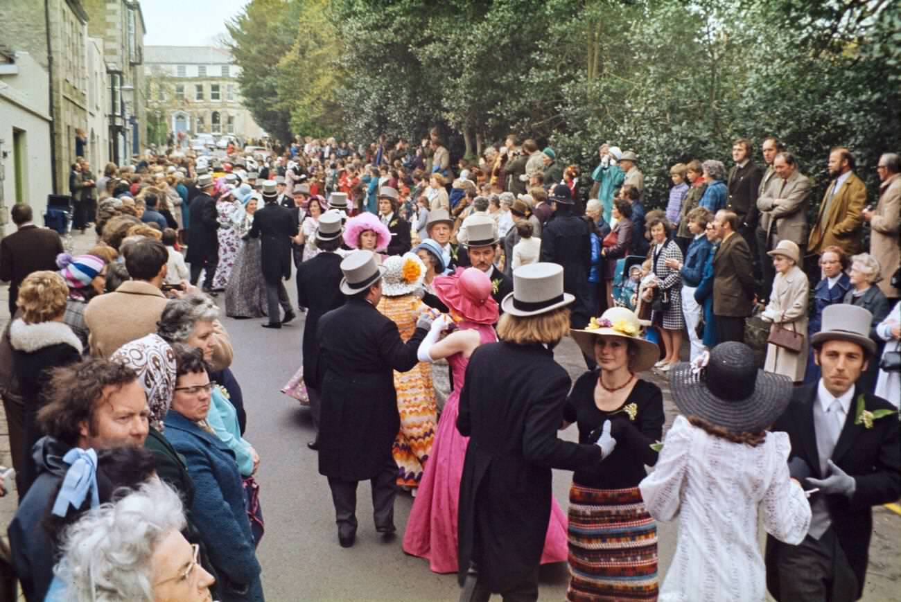 #32 Crowds watch couples perform the Furry dance during Flora Day in Helston, Cornwall, 1973.