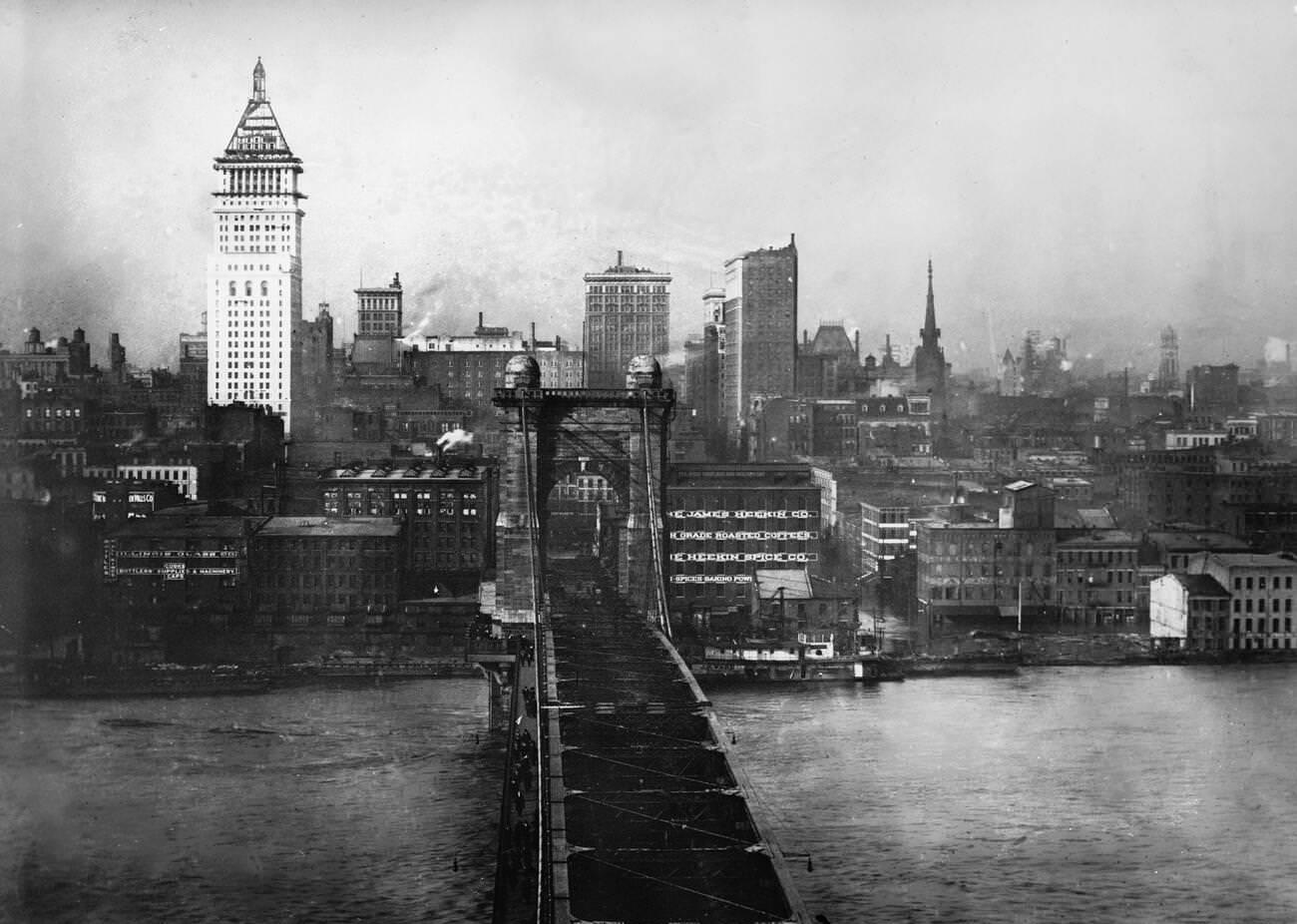 #27 Cincinnati suspension bridge from the Kentucky side looking down on the flooded Ohio River and downtown Cincinnati, 1913.