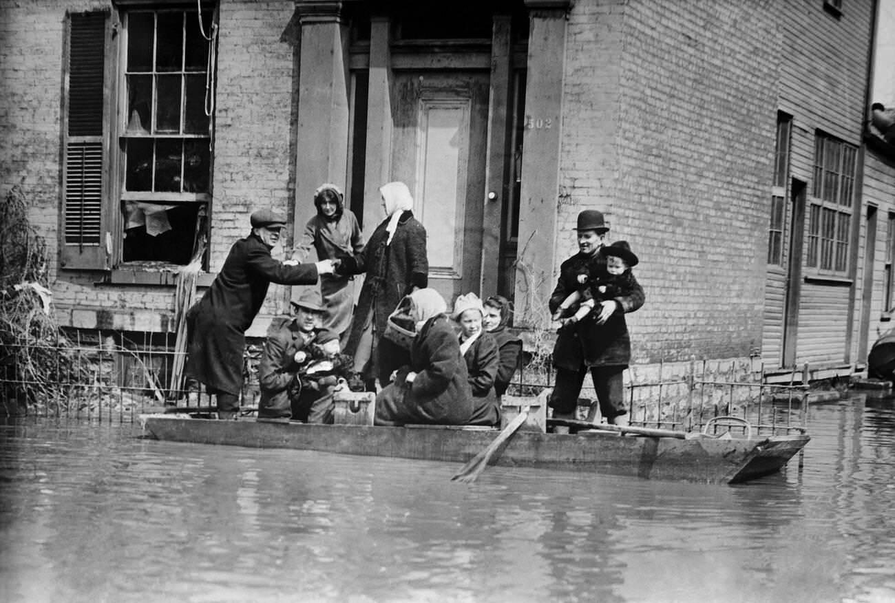 #37 Workers rescuing a family in a rowboat after the flood in Dayton, Ohio, March 1913.