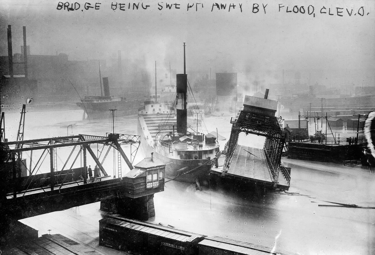 #47 A bridge being swept away during a flood in Cleveland, Ohio, circa 1913.