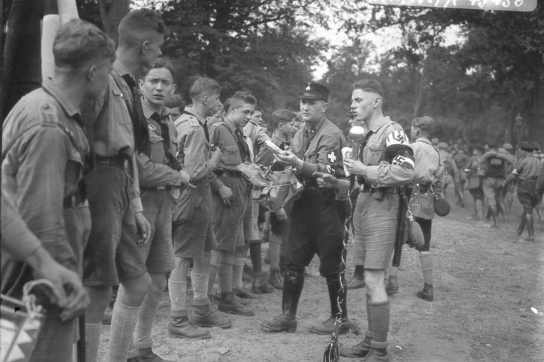 #3 Members of Hitler Youth receiving rations at a camp near Potsdam, Germany, 1932.