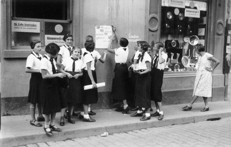#37 Members of the League of German Girls putting up recruiting posters, Worms, Germany, 1933-1945.