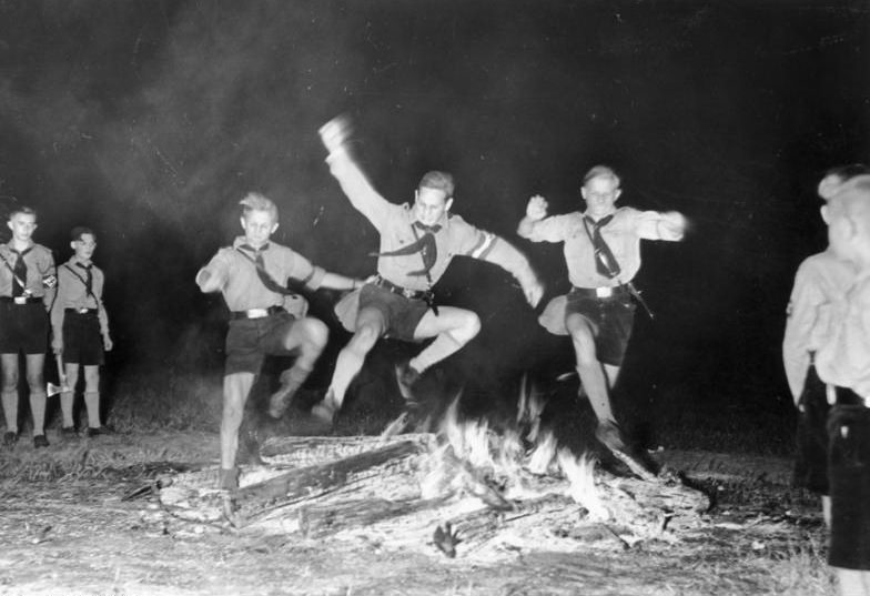 #46 Hitler Youth members jumping over the solstice fire, Berlin, Germany, Jun 1937.