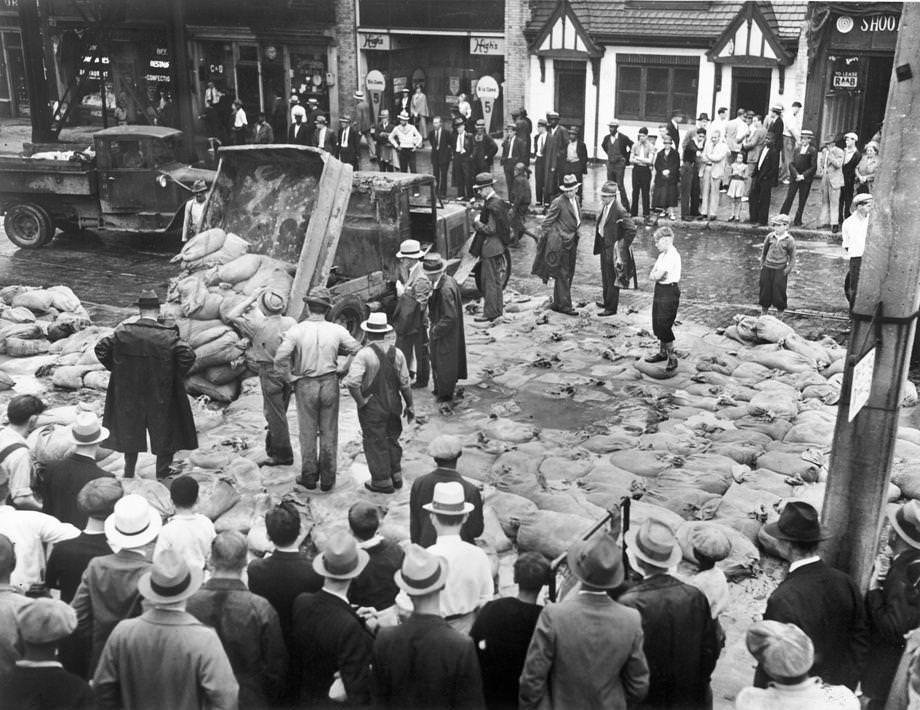 #57 Heavy rain caused the James River to crest at 26 feet. City workmen piled sandbags in a desperate attempt to hold back the rising waters, 1935.
