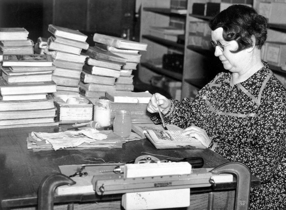 #60 A woman working on a Works Project Administration bookbinding project in Suffolk in which hundreds of books were prepared for use in schools, 1938.