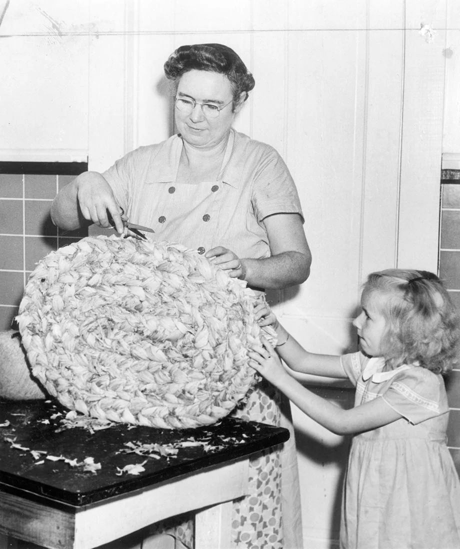 #94 Mrs. James Hicks of James City County and her daughter, Willie Mae, made a cornhusk doormat at home, 1949.
