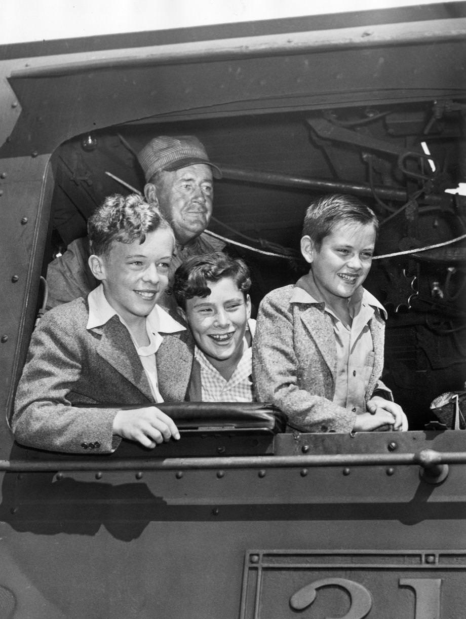 #172 The Quiz Kids learned about railroading from RF&P engineer C.W. Shackleford (rear) during their visit to Richmond to help sell war bonds during World War II, 1943.