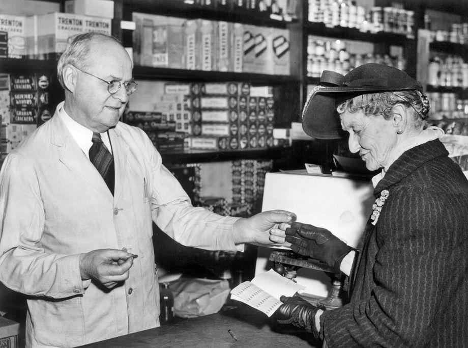 #175 E.W. Saunders, a clerk at R.L. Christian & Co. in downtown Richmond, showed Mrs. L.E. Barber how to use ration tokens, 1944.