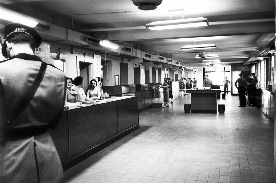 #100 Employees of the Virginia Division of Motor Vehicles on West Broad Street in Richmond prepared for an onslaught of customers before doors opened for business, 1959.
